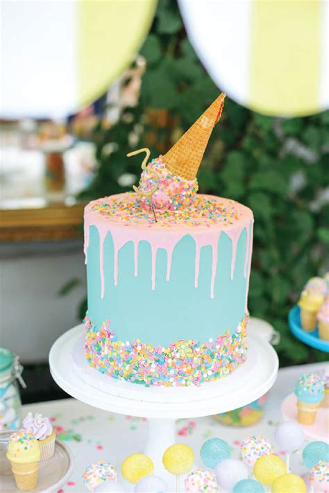 A Birthday Cake Decorated With Sprinkles And An Ice Cream Cone On Top