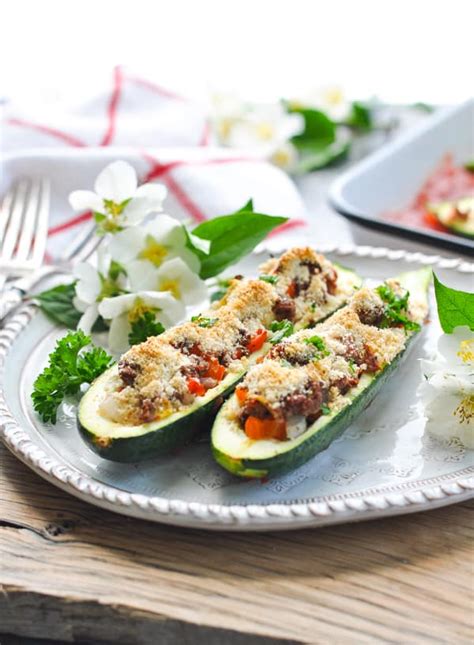 Add 1/2 cup of the cheese, the tomatoes, cracker crumbs and basil; Easy Stuffed Zucchini Boats - The Seasoned Mom