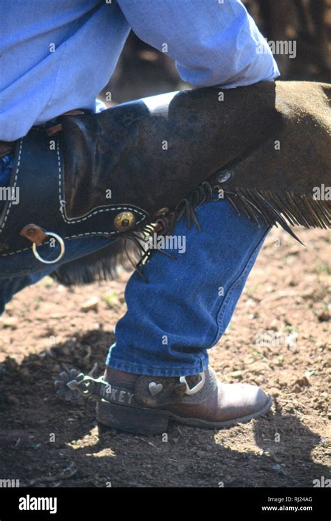 Cowboy Participating In A Spring Branding Kneeling Stock Photo Alamy