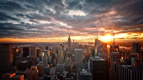 Download 2560x1440 New York Sunset Dark Clouds Buildings Cityscape