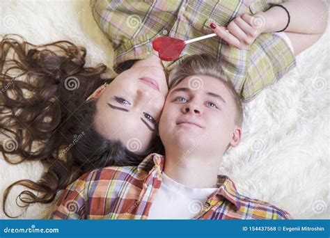 Young Loving Couple Kiss Each Other Cover Their Lips With A Candy In