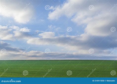 Scenic Landscape With Green Field And Blue Sky With Soft Clouds Stock