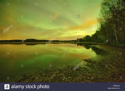 Northern Lights Aurora Borealis Glowing In The Night Sky Over A
