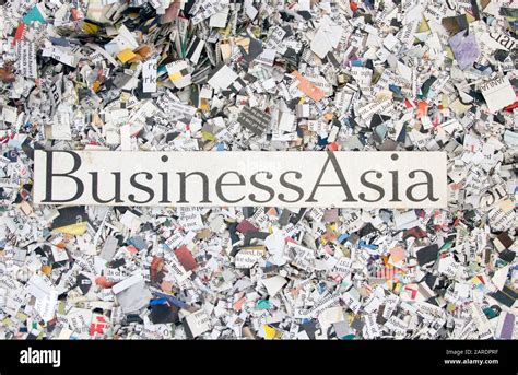 Newspaper Confetti From Above With The Words Business Asia Background