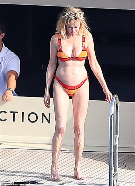 Melanie Griffith Shows Off Her Toned Bod As She Takes A Dip Off A
