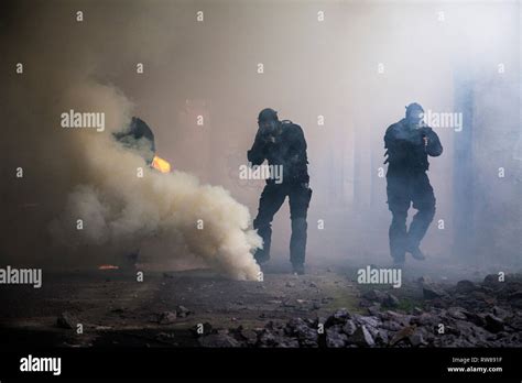 Special Forces Operators In Black Uniforms In The Smoke Stock Photo Alamy