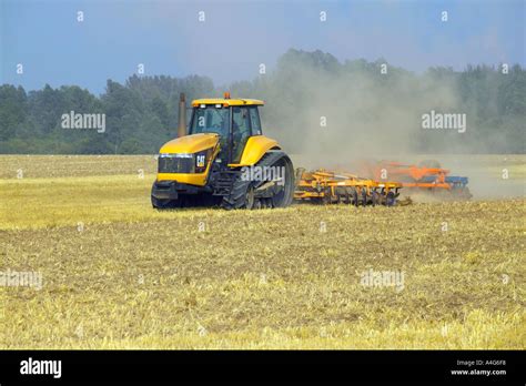 Caterpillar Tractor And Disc Harrow Stock Photo Alamy