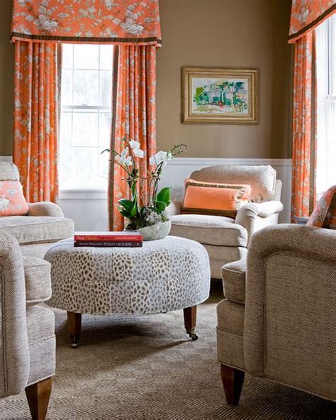 A Living Room Filled With Furniture And Orange Curtains