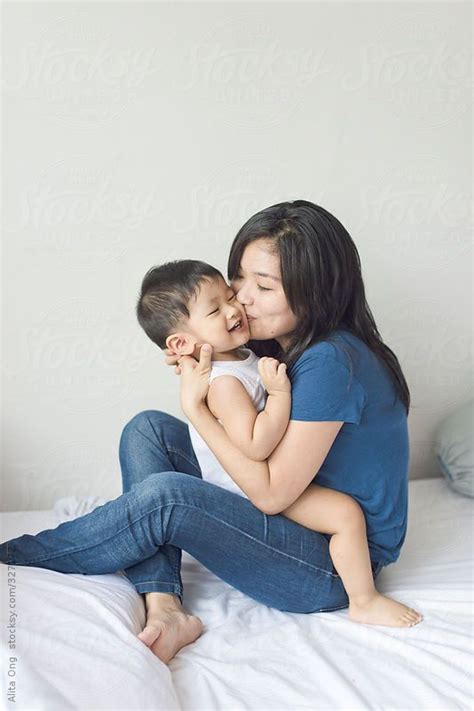 Young Asian Mother Kissing Her Son By Alita Stocksy United Japanese Mom Biological Father