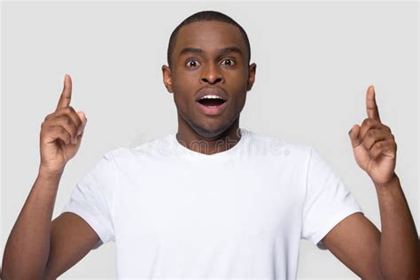 African Guy Open Mouth Feels Amazed Pointing Fingers Up Stock Photo