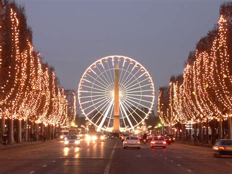 The Avenue Des Champs Élysées Is A Busy Street With Its Cinemas Cafés