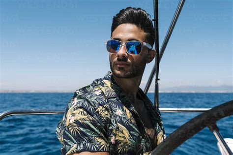Handsome Young Man Wearing Sunglasses Traveling In Yacht Stock Photo
