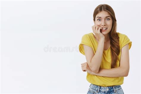Concerned Panicking Timid And Insecure Attractive Young Woman In Casual Yellow T Shirt With Cute