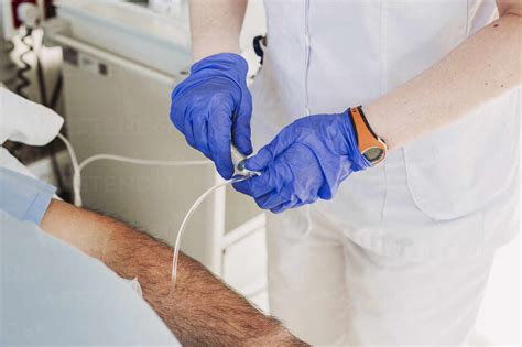 Nurse Adjusting Iv Drip For Patient Lying In Hospital Bed Stock Photo
