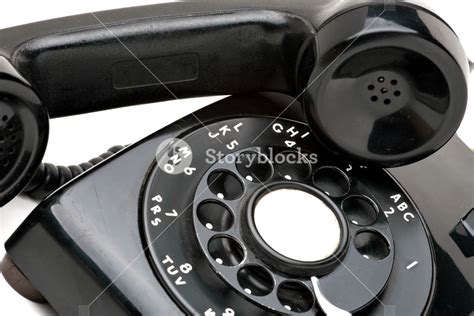 An Old Black Vintage Rotary Style Telephone Off The Hook Isolated Over