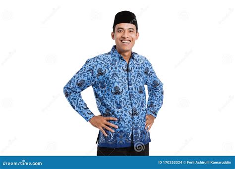 Asian Young Man Wearing Batik Korpri With Hand On The Waist Stock Photo