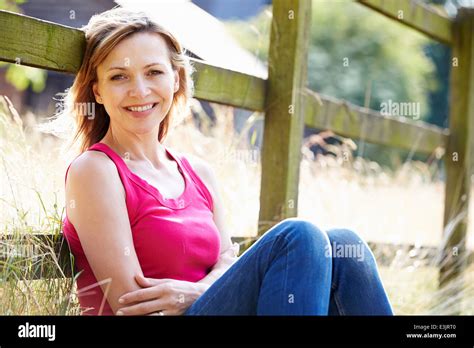 Attractive Woman Relaxing On Walk In Countryside Stock Photo Alamy