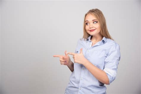 Free Photo Beautiful Young Woman Pointing At Somewhere