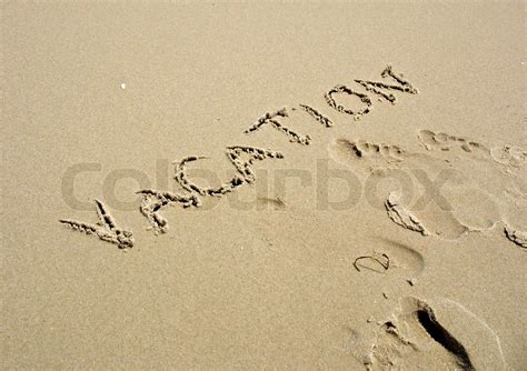 The Word Vacation Written In The Sand Along With Some Footprints
