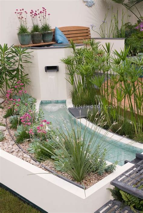Understanding the principles of modernist design makes it possible to fill out the contemporary plant list with species and cultivars that weren't available 50 years ago yet are still appropriate to the philosophy. Waterfall in modern water garden with raised beds ...