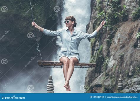Photo Of Woman Riding Swing In Front Of Waterfalls Picture Image