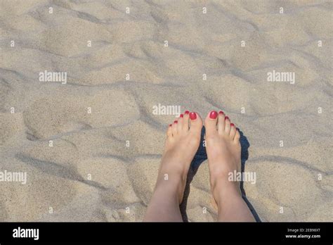 Female Feet On Beach Sand Woman S Feet With Red Nails On Seashore Sand