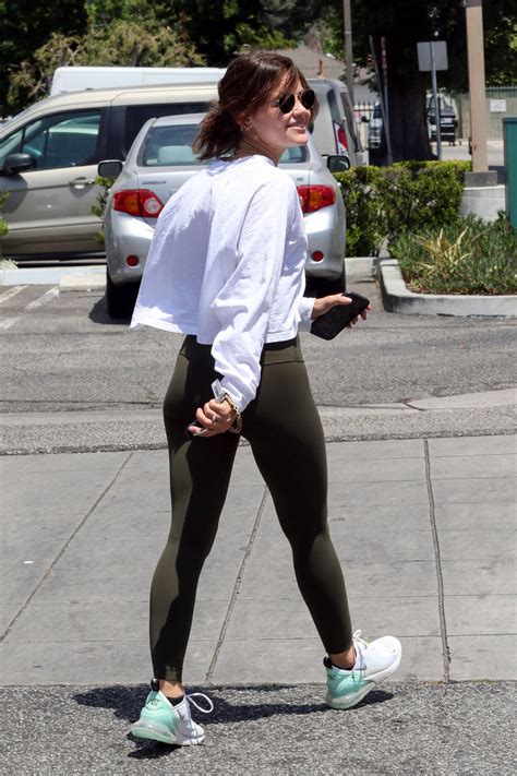 Lucy Hale Sports A White Sweatshirt And Olive Green Leggings While She