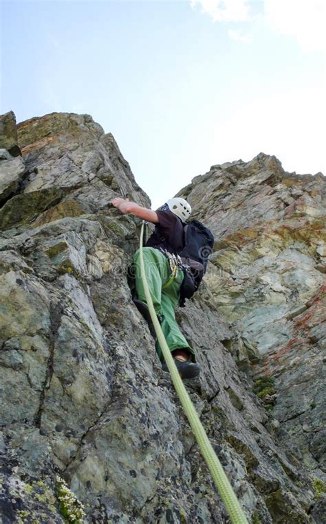 Male Rock Climber On A Steep Granite Climbing Route In The Swiss Alps