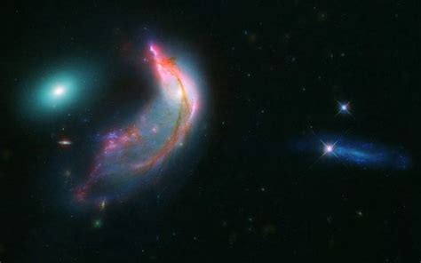 Nasa Shows A Striking Galaxy Duo Resembling A Penguin With Its Egg
