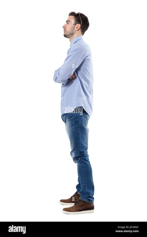 Side View Of Young Businessman With Crossed Arms Looking Away Full