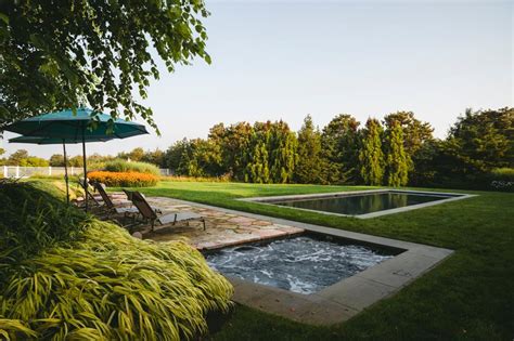Stylish Backyard Swimming Pool And Hot Tub With Poolside Lounge Chairs