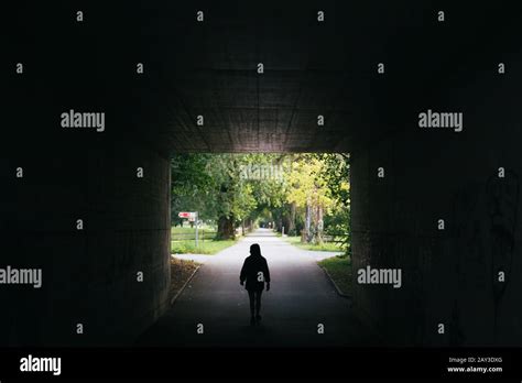 Silhouette Of Person Walking Through Tunnel Stock Photo Alamy