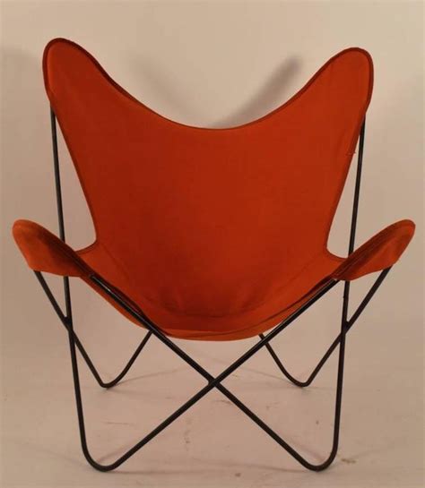 This pair of chairs feature a black enameled tubular framework with canvas sling seat, canvas cushio. Hardoy Butterfly Chair with Original Orange Canvas Sling ...