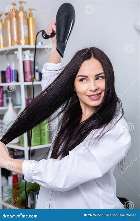 Professional Hairdresser Washing Hair Of Young Woman In Beauty Salon