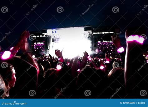 Silhouettes Of Concert Crowd In Front Of Bright Stage Lights Editorial