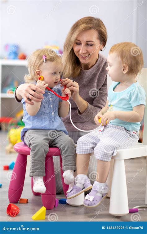 Children Learning With A Teacher Are A Doctor And Patient Stock Image