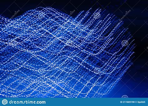 Abstract Background With Blue Neon Lights Wavy Lines On Black