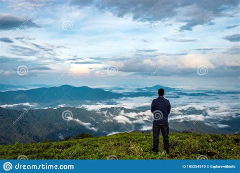 Man Isolated Feeling The Serene Nature At Hill Top With Amazing Cloud