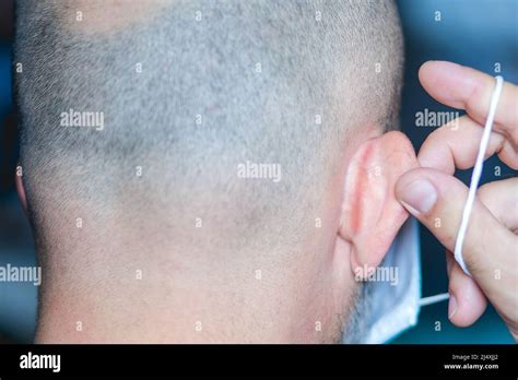 Man With Ear Skin Irritation From Wearing A Face Mask Stock Photo Alamy