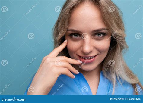 Photo Of Shy Cute Casual Young Woman With Smiling Eyes On Bright Blue Background Stock Image