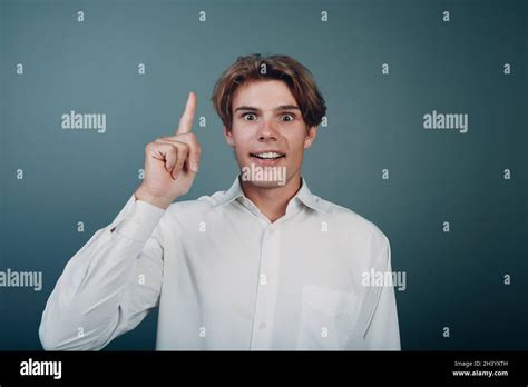 Young Man Pointing And Forefinger Index Finger Up Stock Photo Alamy