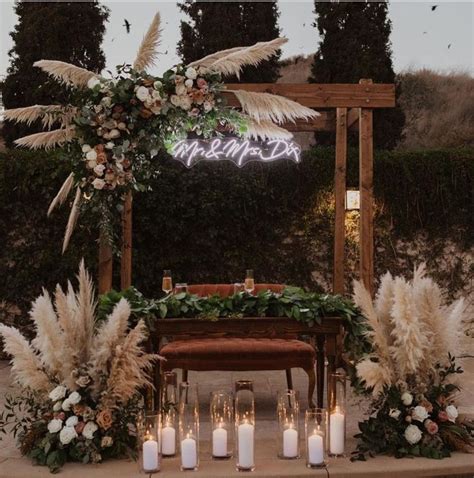 An Outdoor Wedding Setup With Candles And Flowers