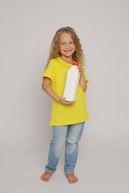 Premium Photo A Blonde Girl In A Yellow Tshirt With A Plastic Bottle