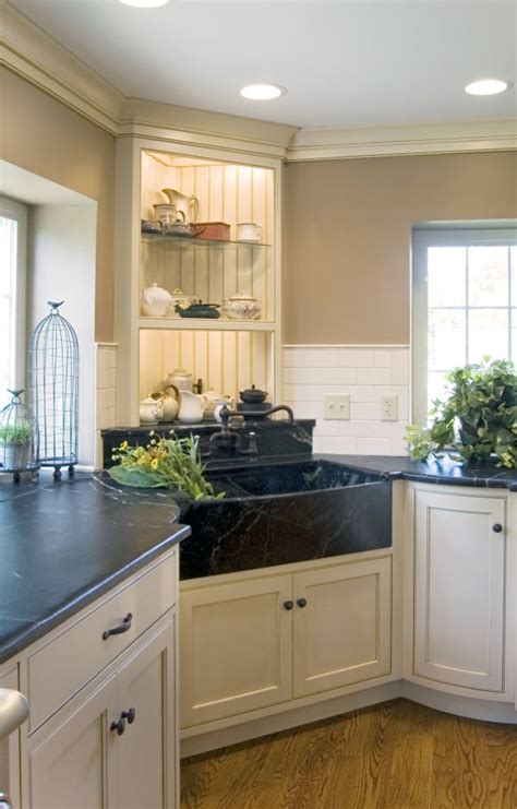 Consider placing the sink in the corner of the kitchen. Corner Farmhouse sink - not in front of a window so the ...