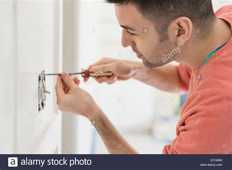 Young Man Installing Light Switch At Home Stock Photo Alamy