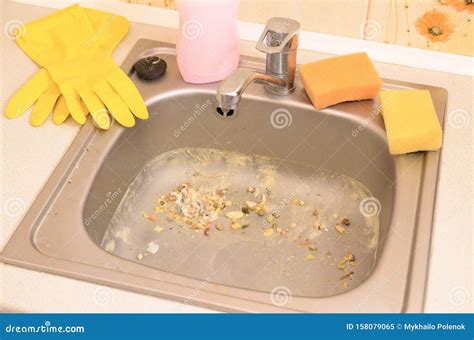 Close Up On Dirty Clogging Kitchen Sink Drain With Food Particles Stock
