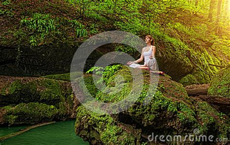 Relaxation In Forest At The Waterfall Ardha Padmasana Pose Stock Photo