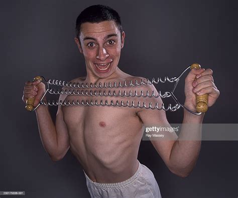 Bare Chested Young Man Using Chest Expander Smiling Portrait Photo