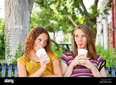 Two Girls Sitting On Park Bench Hi Res Stock Photography And Images Alamy