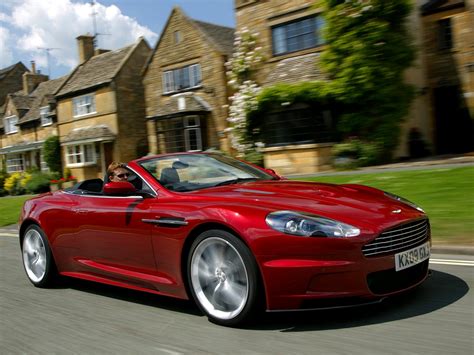 Timelapse photo of red Aston Martin DB9 on gray asphalt pavement HD
